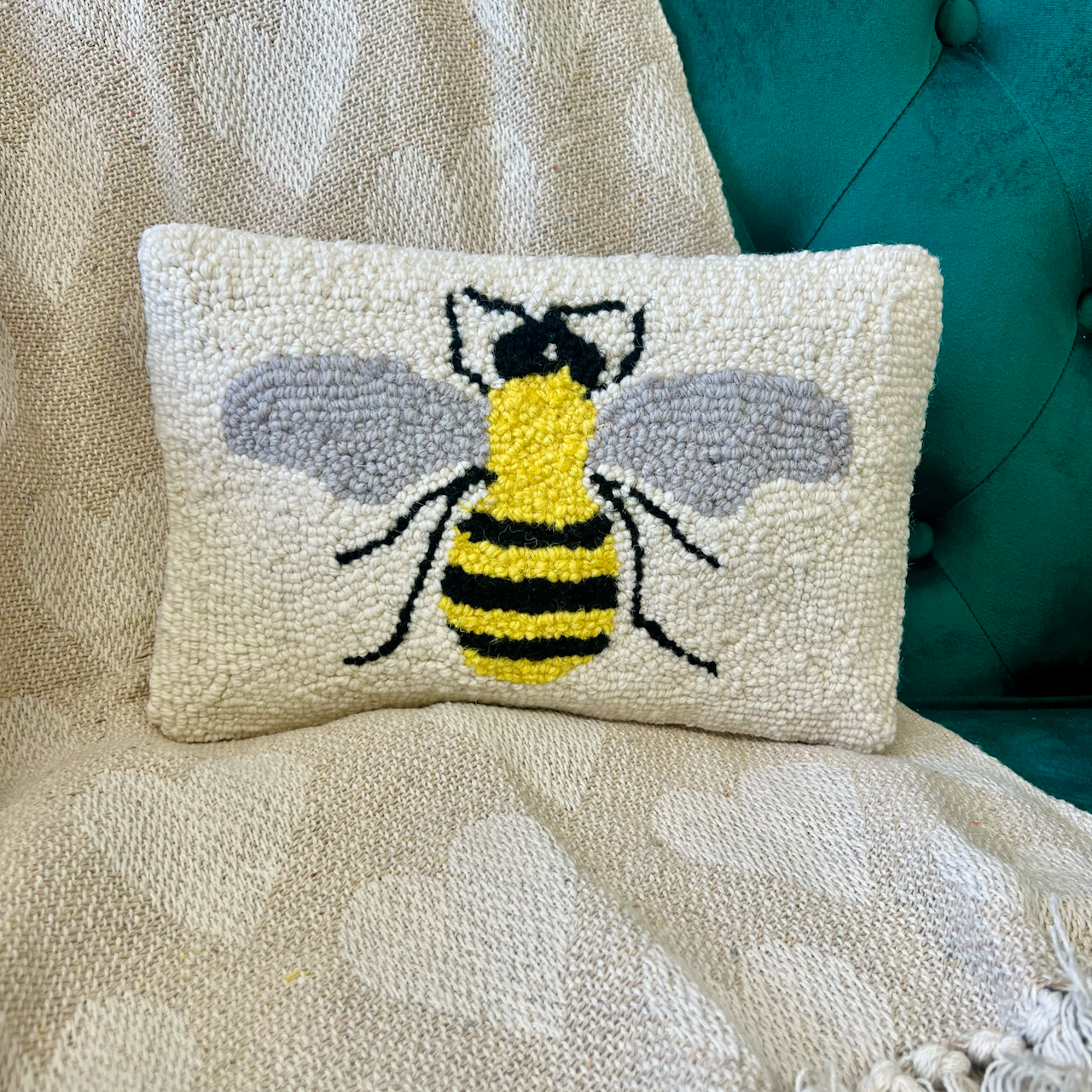bee pillow detailed in green chair