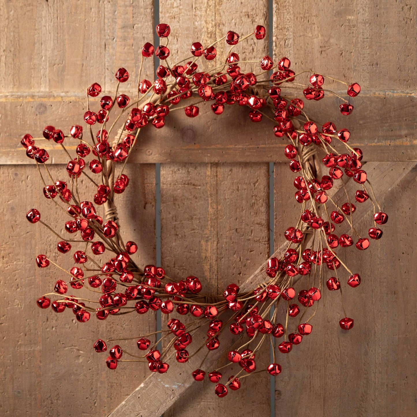 Red jingle bell wreath on a wooden door