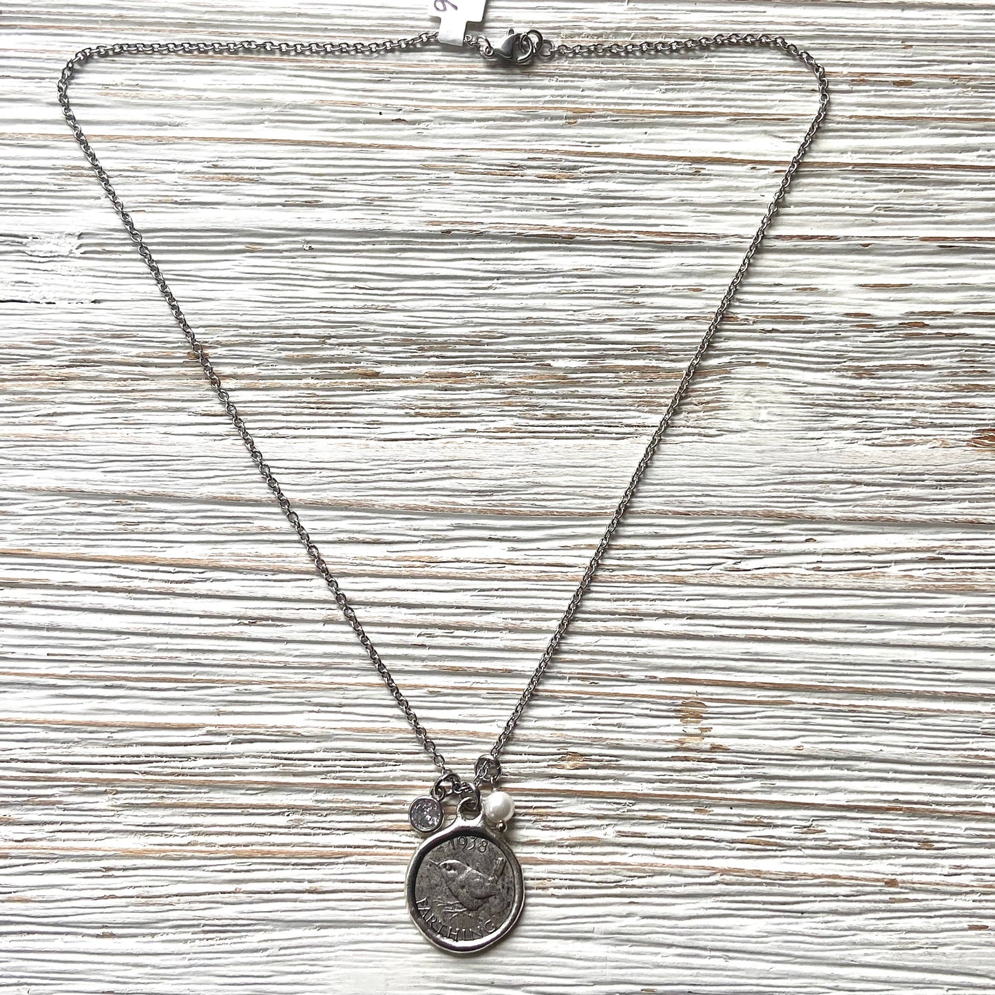Necklace with pendant on a textured wooden surface