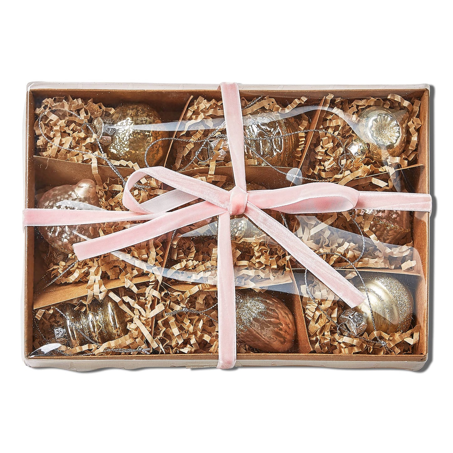 Box of Christmas ornaments with a pink ribbon on a white background