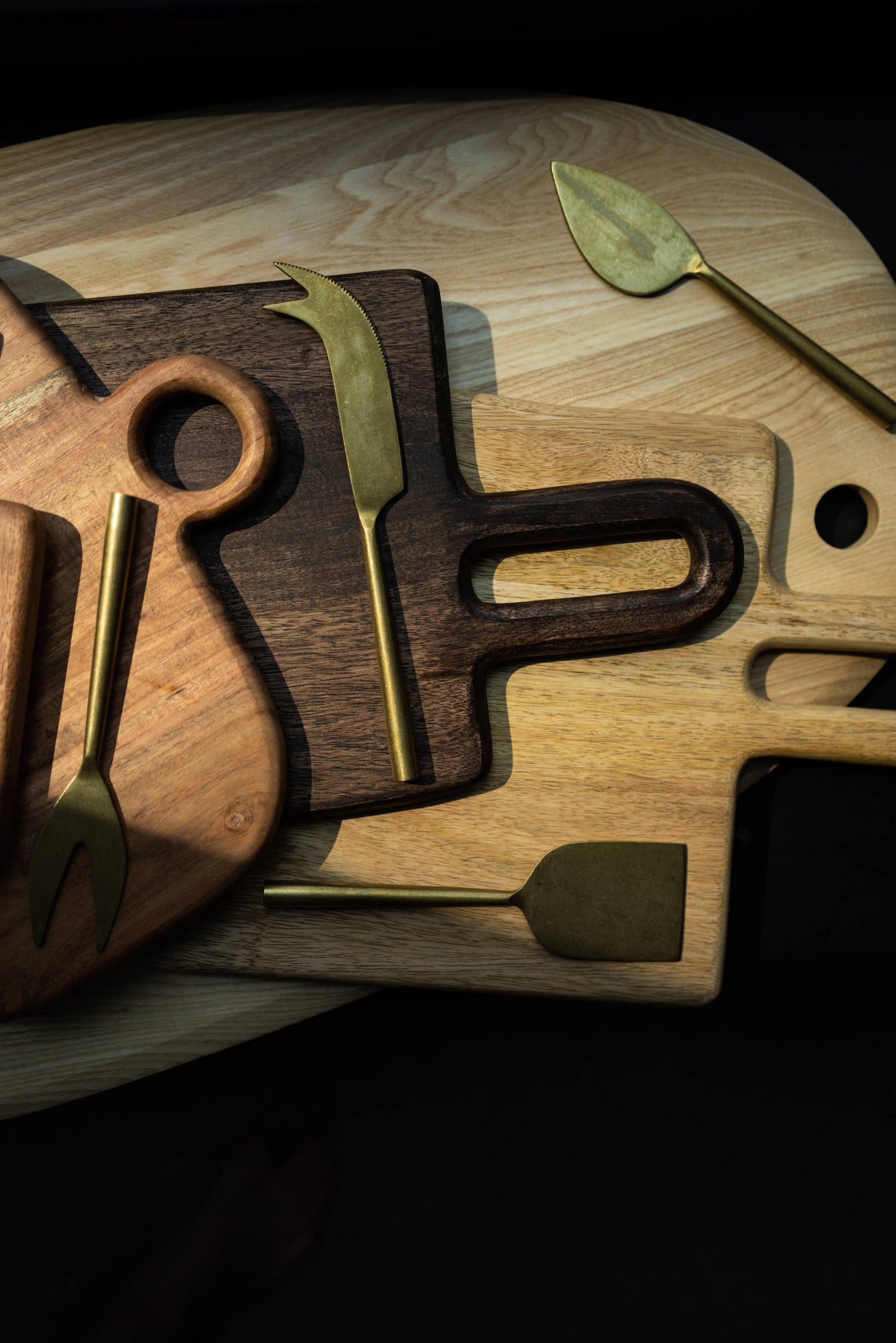 wood cutting boards with gold cheese knives