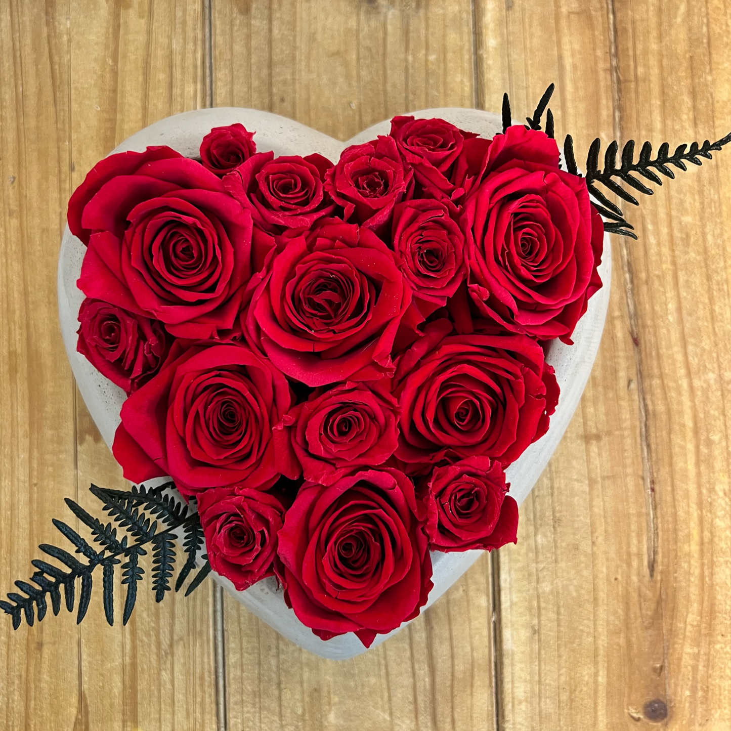 everlasting red roses in a cement heart