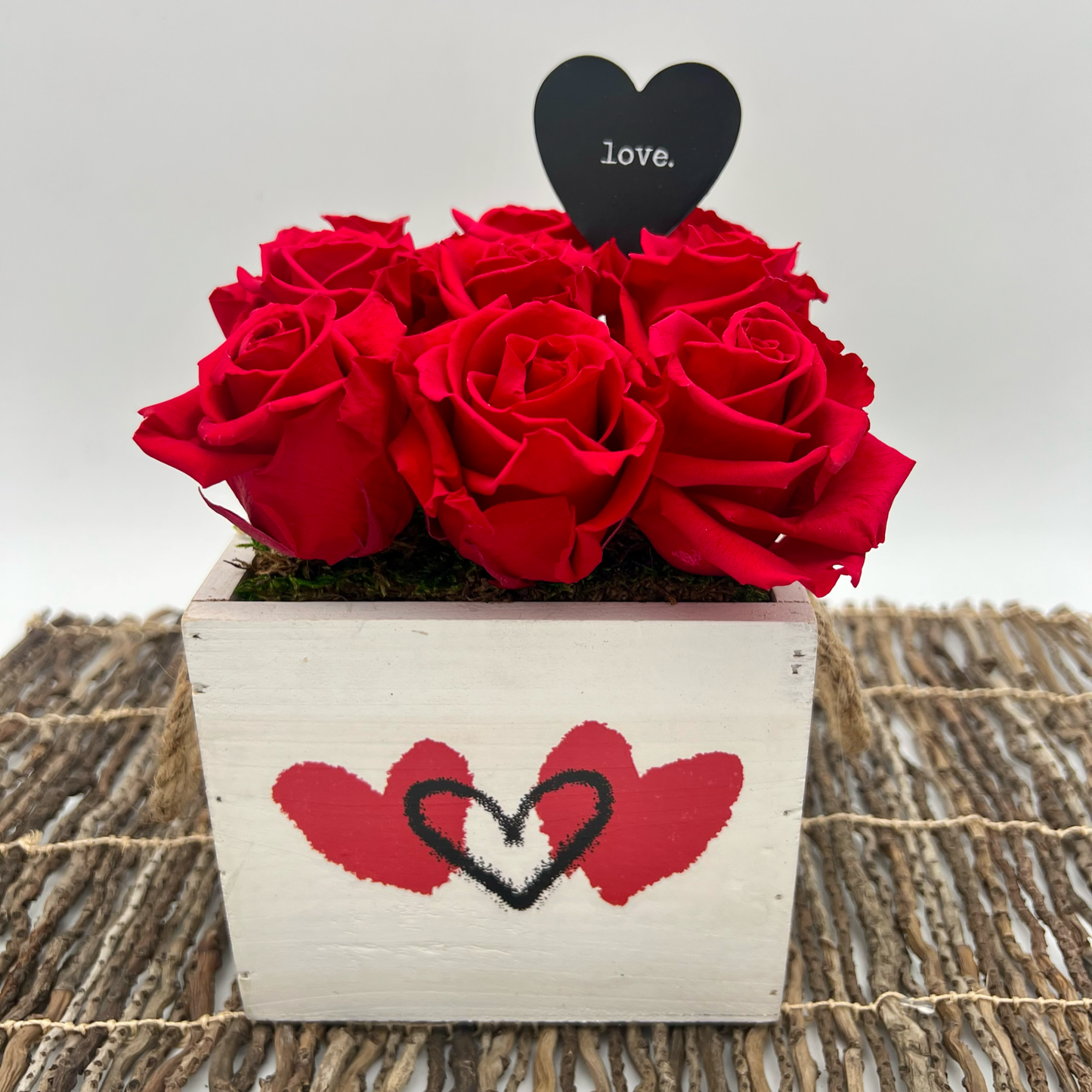 everasting red roses in a wood box