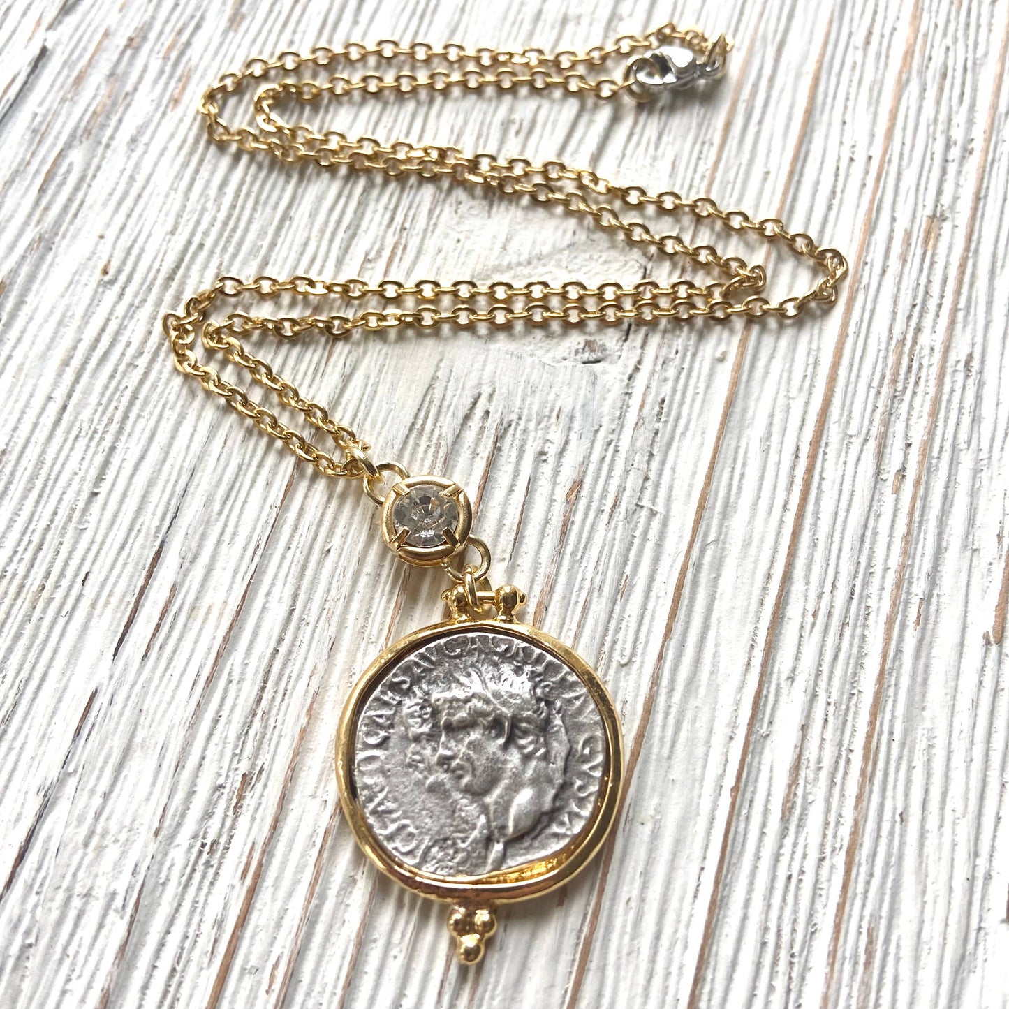 Necklace with a coin pendant on a wooden surface