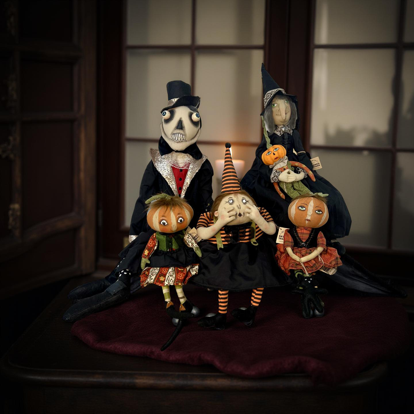 Halloween-themed figurines with pumpkins and witches in a dark setting