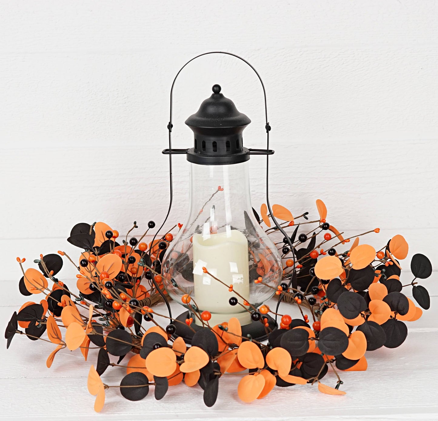 Decorative lantern with black and orange branches on a white background