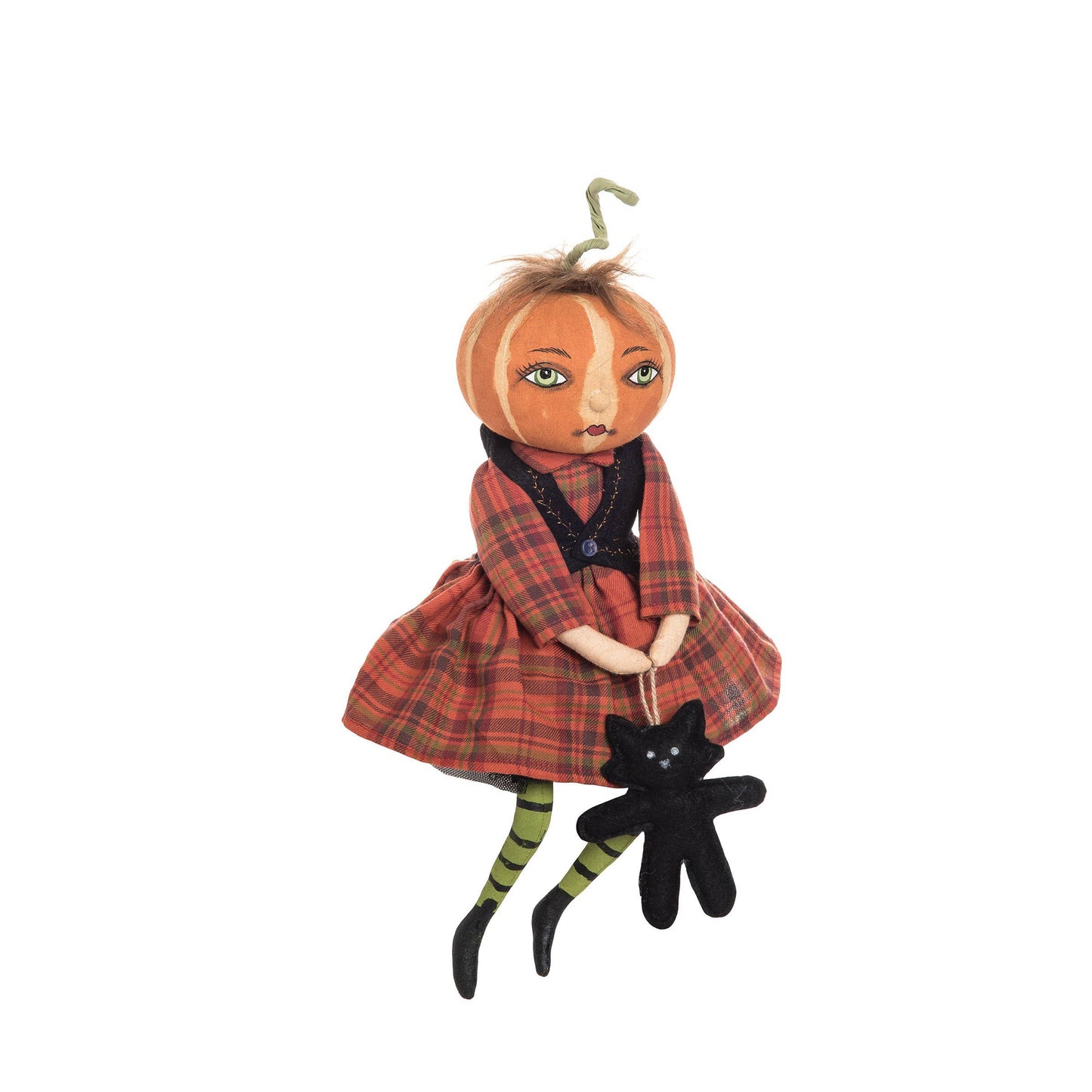 Joe Spencer Pumpkin doll wearing a plaid dress with a black cat toy on a white background