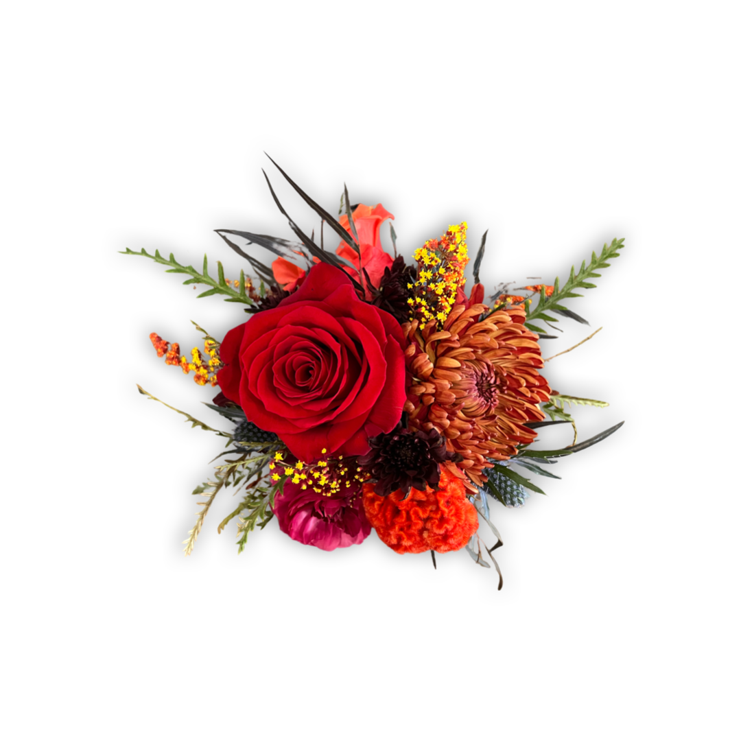 Colorful flower arrangement with red rose, orange dahlia, and greenery on a white background