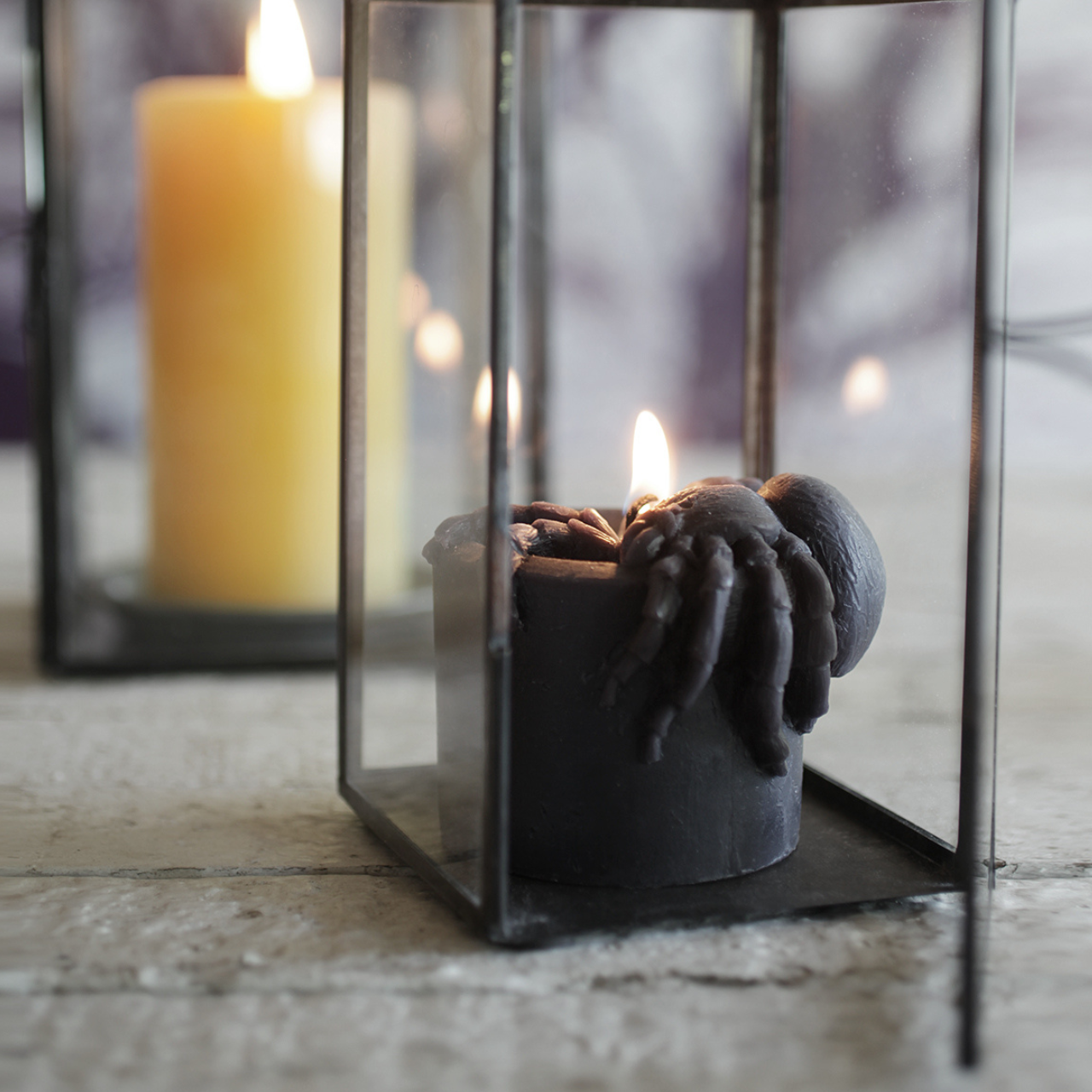 Candle in a glass lantern with a blurred background