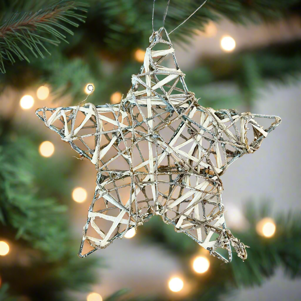 Star-shaped decorative item made of interwoven sticks on a wooden surface