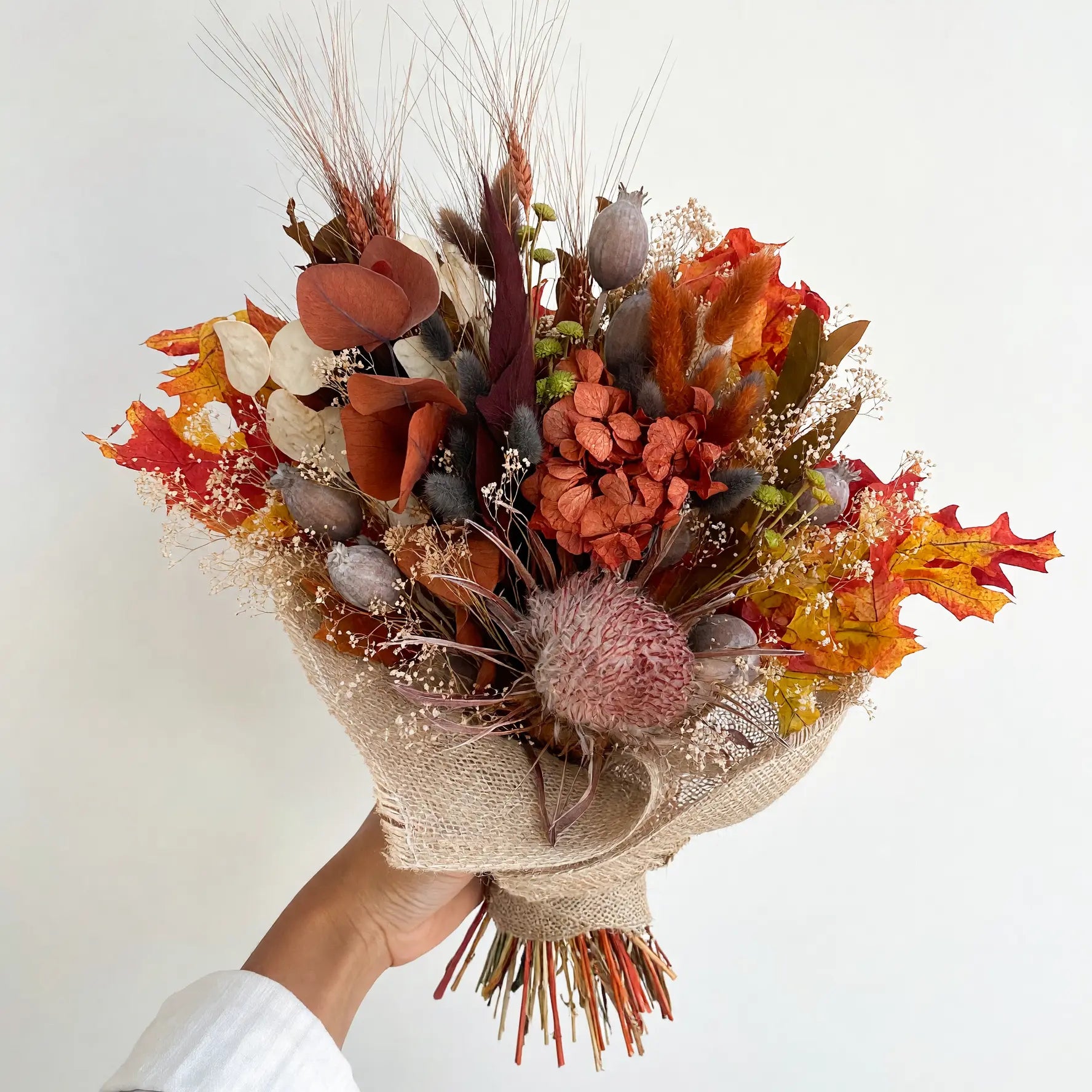 Autumn dried flower bouquet wrapped in burlap