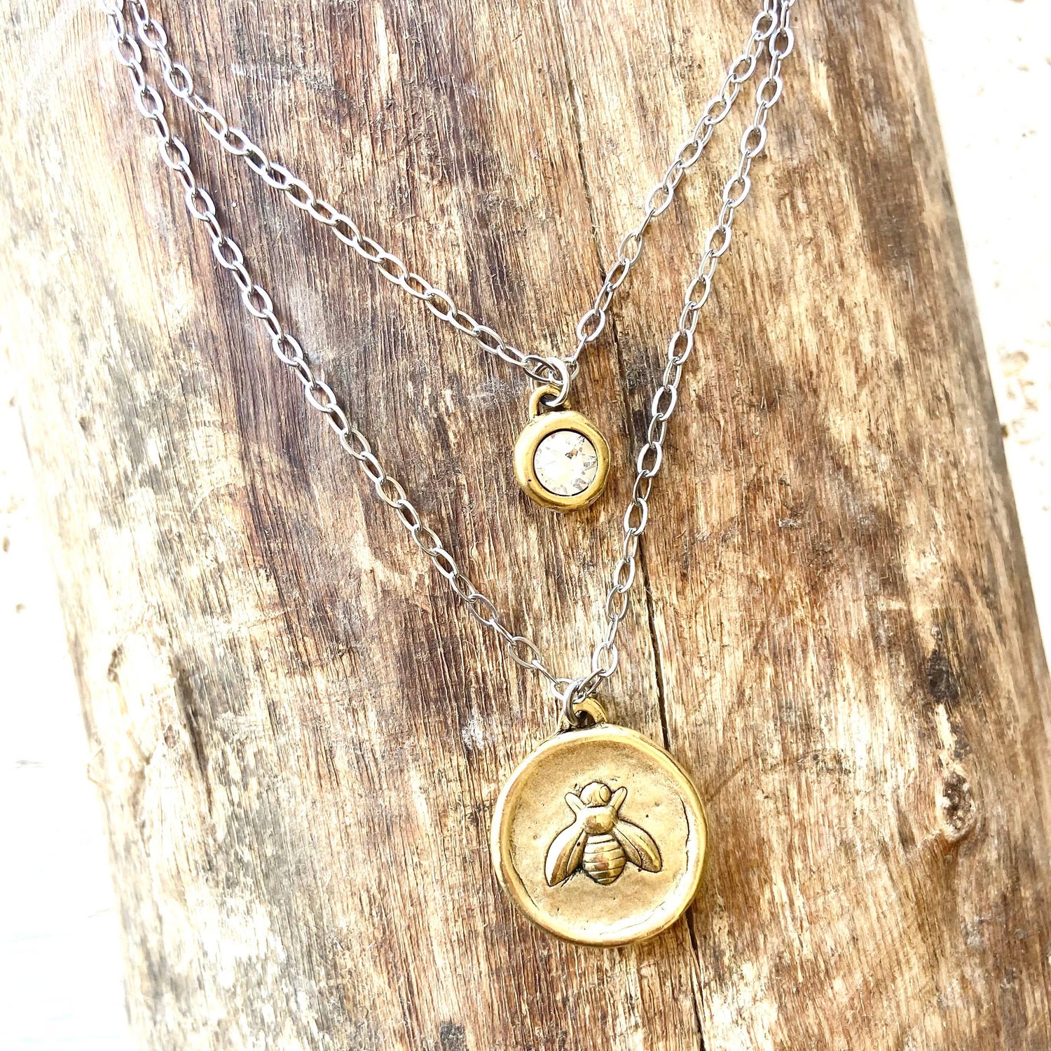 closeup of bee coin necklace