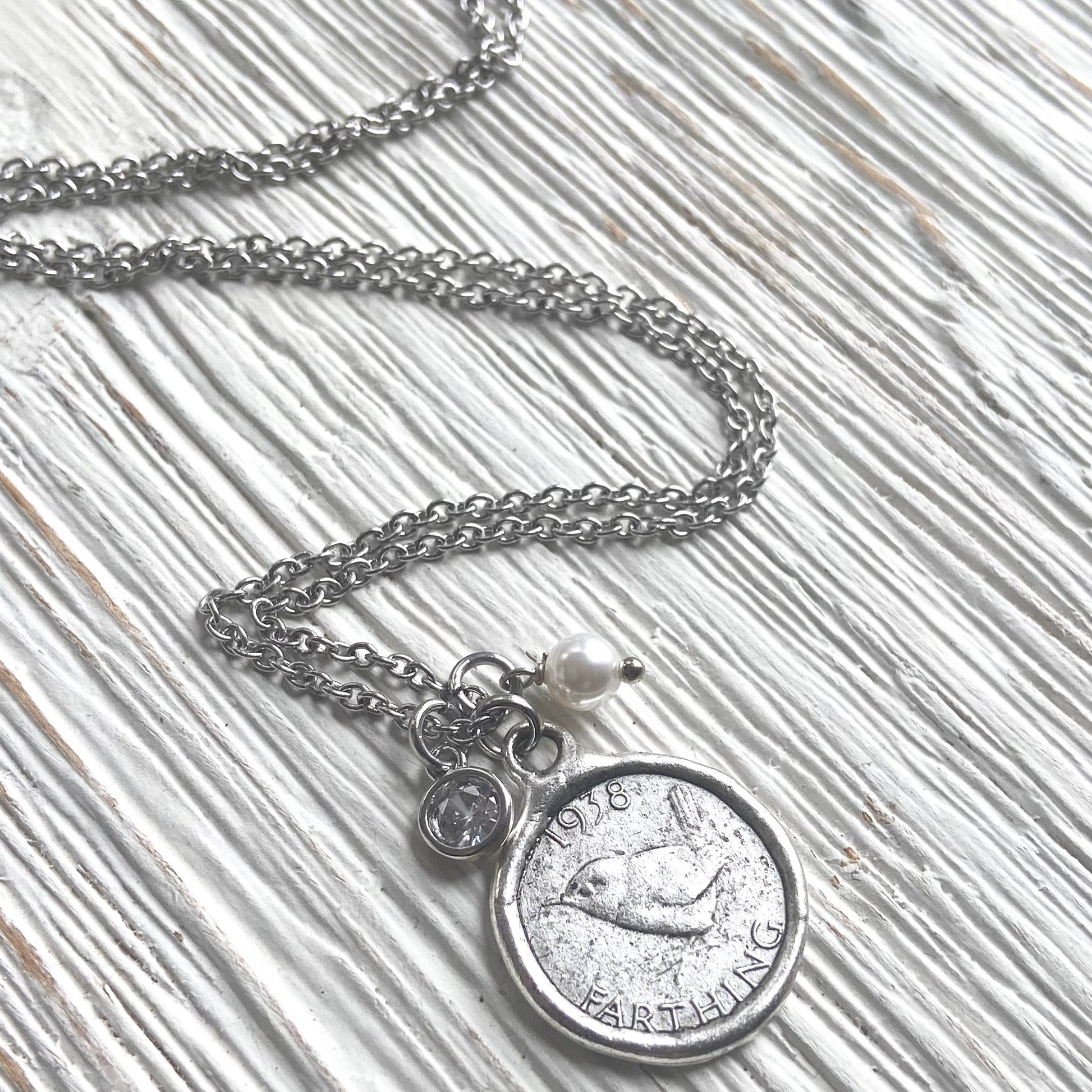 Necklace with a coin pendant on a textured surface