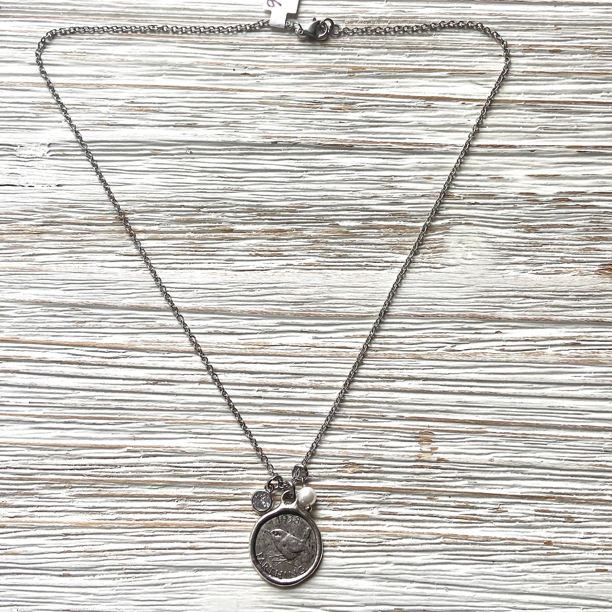 Necklace with pendant on a textured wooden surface