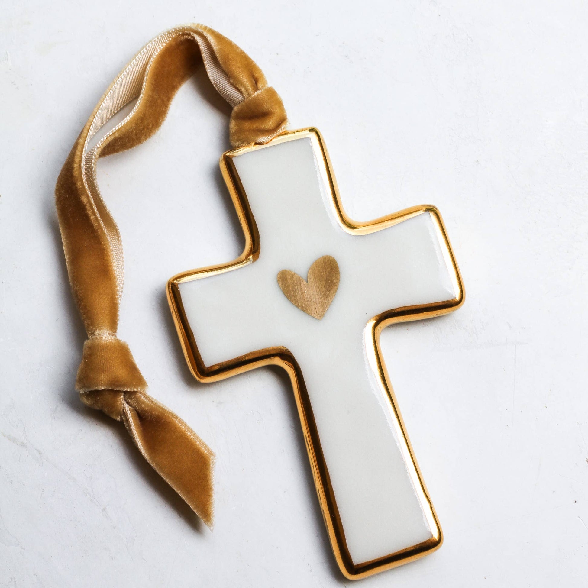 ceramic cross with gold velvet ribbon