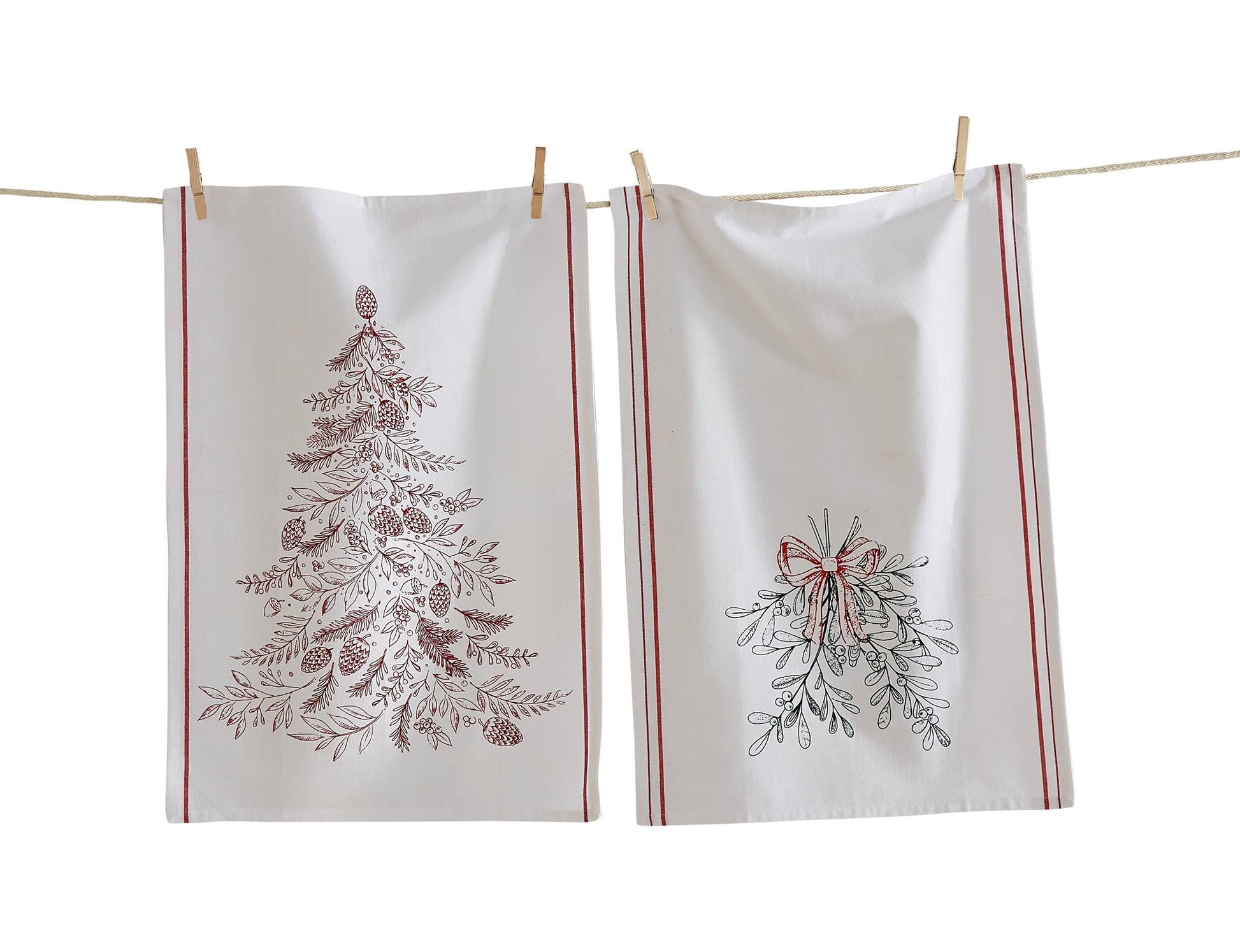 Two white towels with Christmas tree and mistletoe designs hanging on a line.