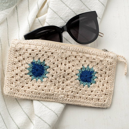 crochet pouch with black sunglasses on a white background