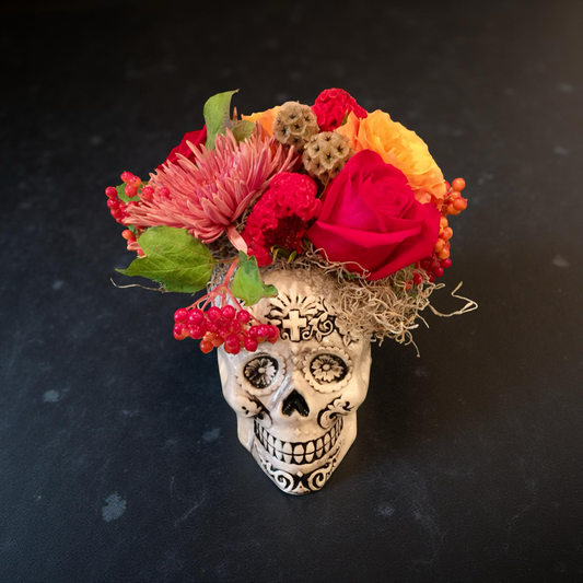 Decorative skull with colorful flowers on a dark background