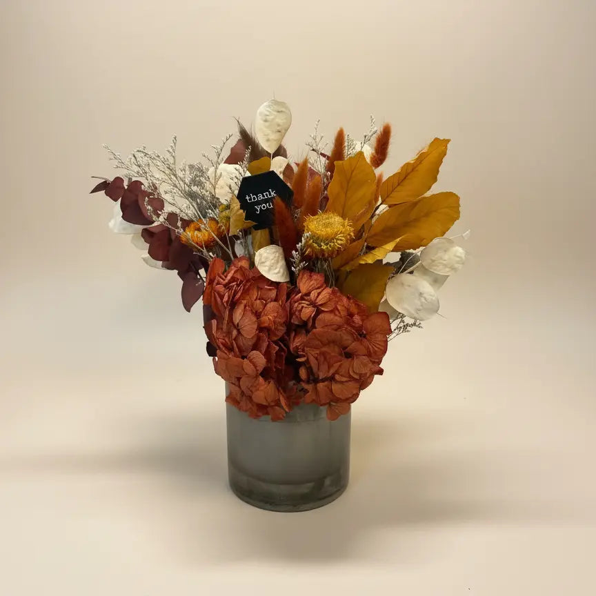 earthone dried flower bouquet in a metal vase