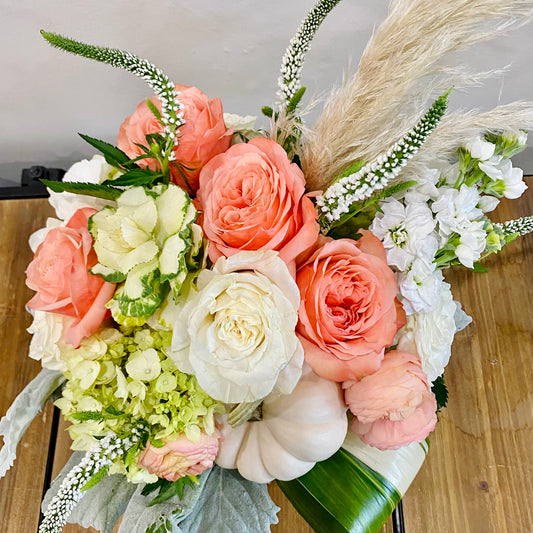 Bouquet of peach, white, and green flowers exclusively at Thimbleberry House