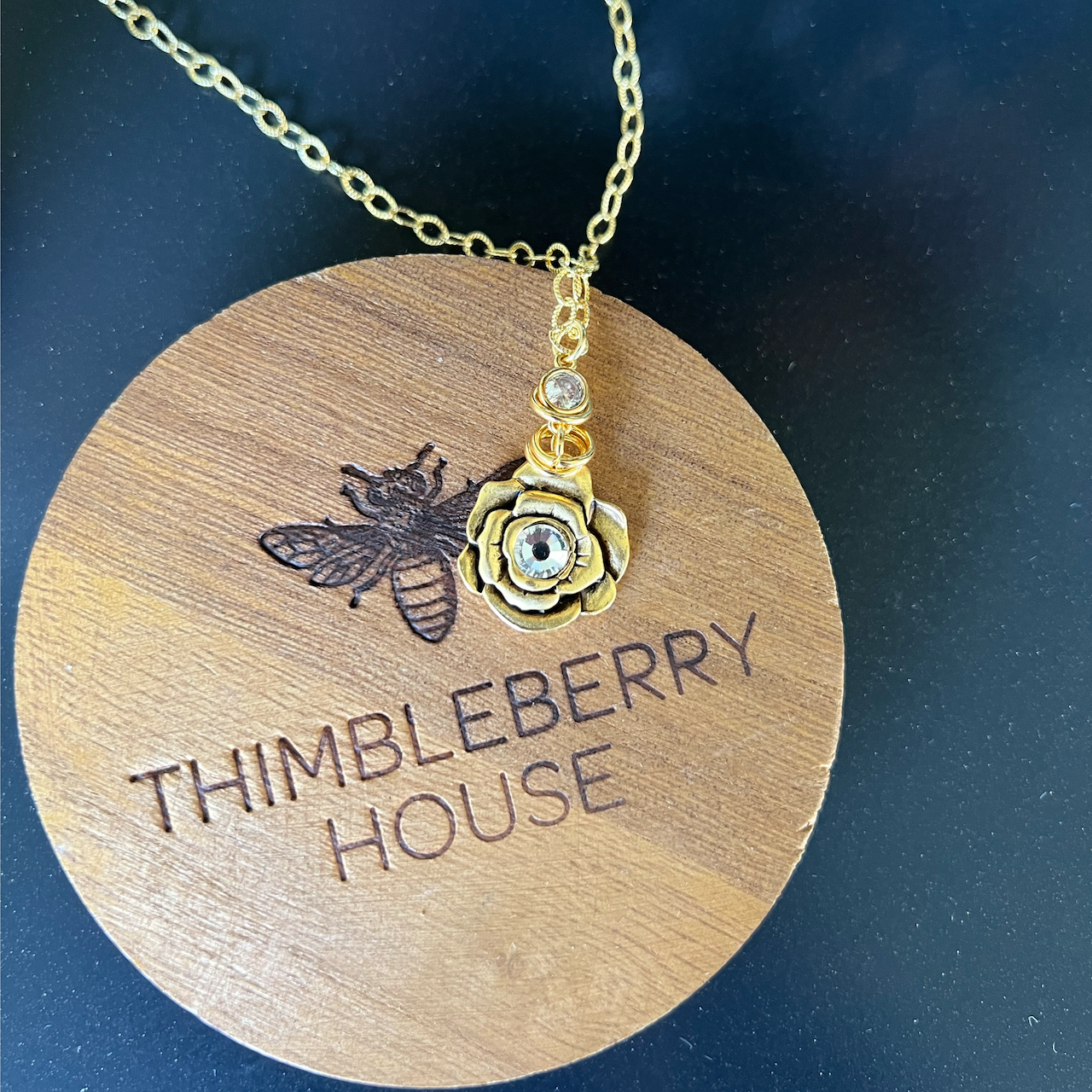 flower necklace on our thimbleberry house lid