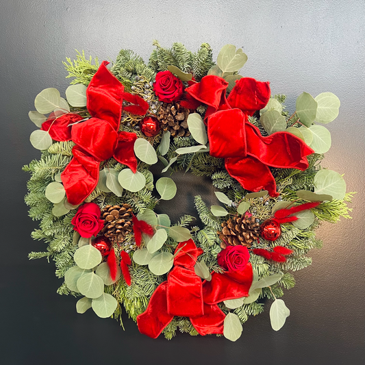 fresh holiday wreath with red accents