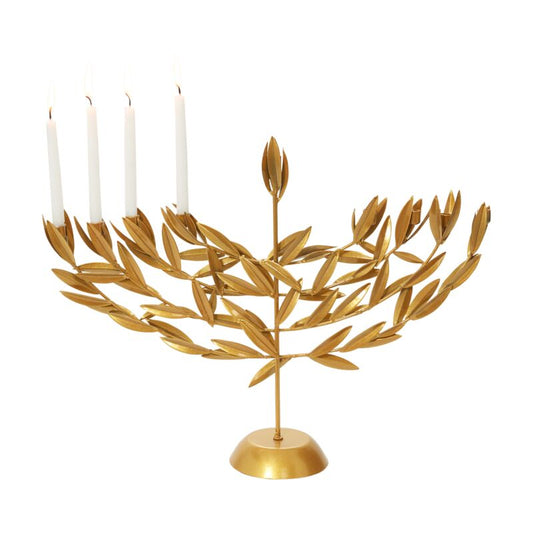 Gold leaf menorah with white candles on a white background