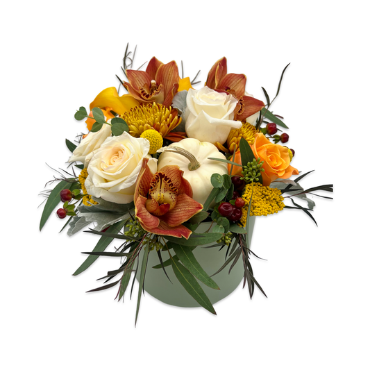 Golden Hour fresh flower arrangement with bronze, orange, and gold blooms accented with cream and white flowers in a ceramic vessel