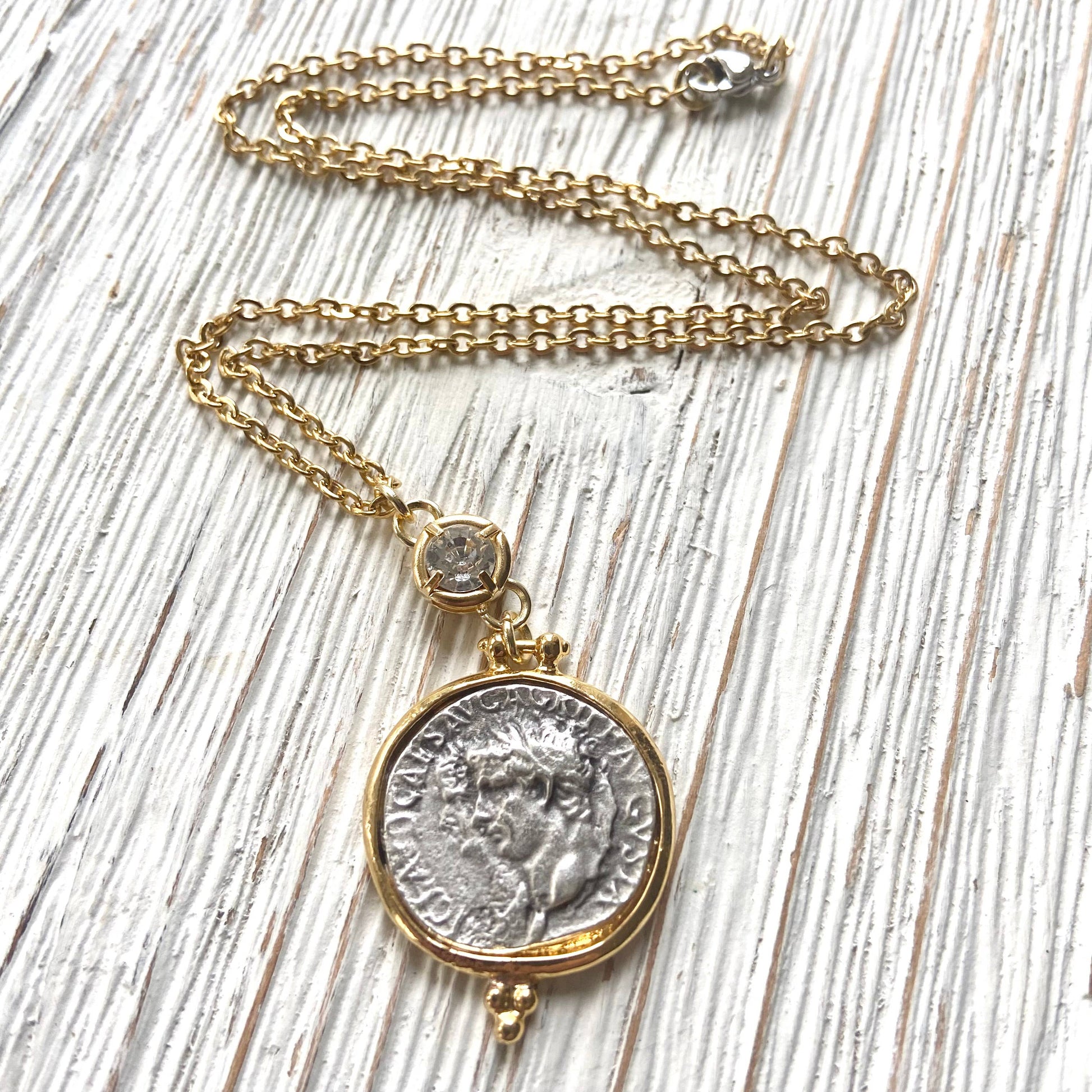 Necklace with a coin pendant on a wooden surface