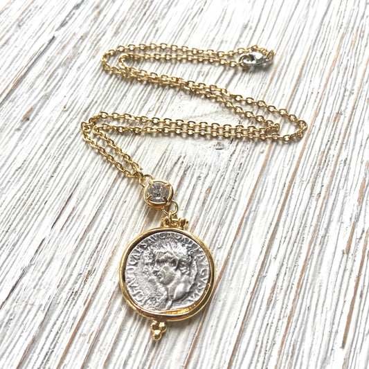 Necklace with a coin pendant on a wooden surface