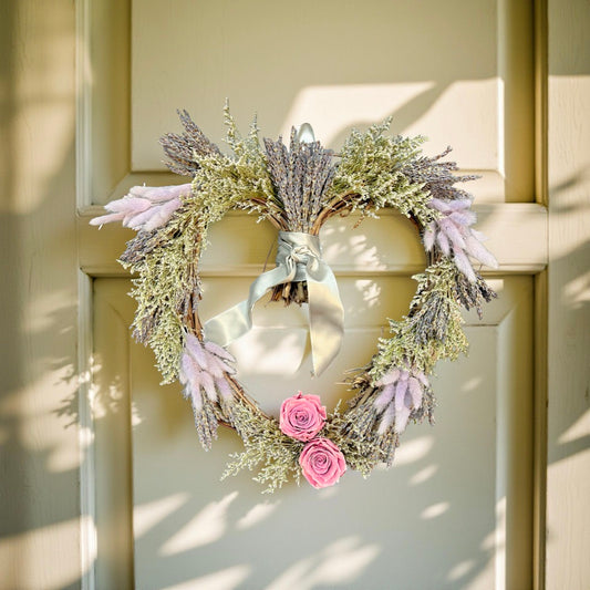 heart wreath with lavender on a light colored door with sunlight