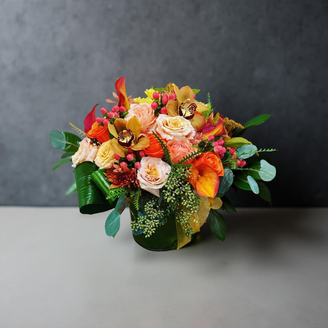 Hello, Fall luxury flower arrangement with calla lilies, roses, and orchids in warm peach, orange, and bronze tones