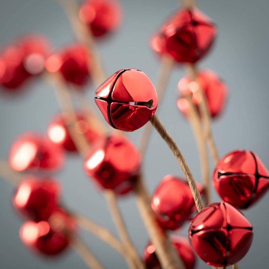 Close-up of red jingle bells on a gray background
