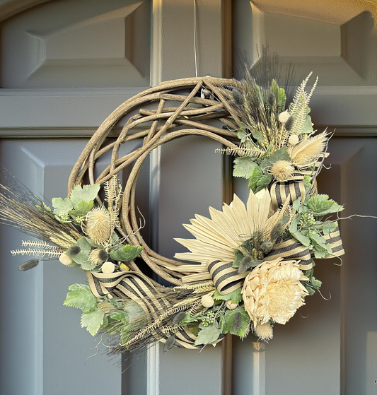 everyday preserved and dried wreath hanging on a front door