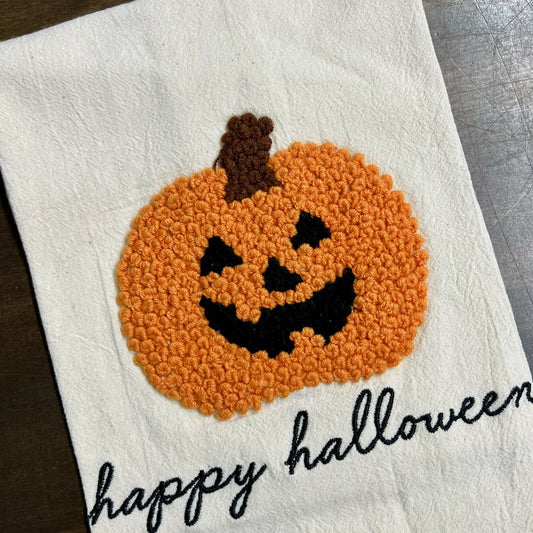 White towel with a jack-o'-lantern design and 'happy Halloween' text.