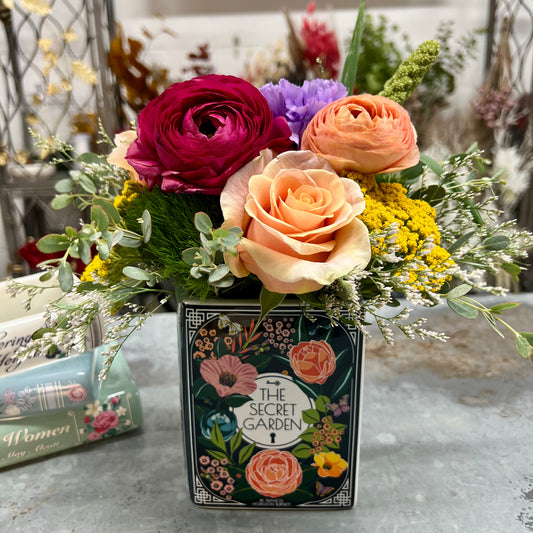 A book vase with fresh flowers from Thimbleberry House