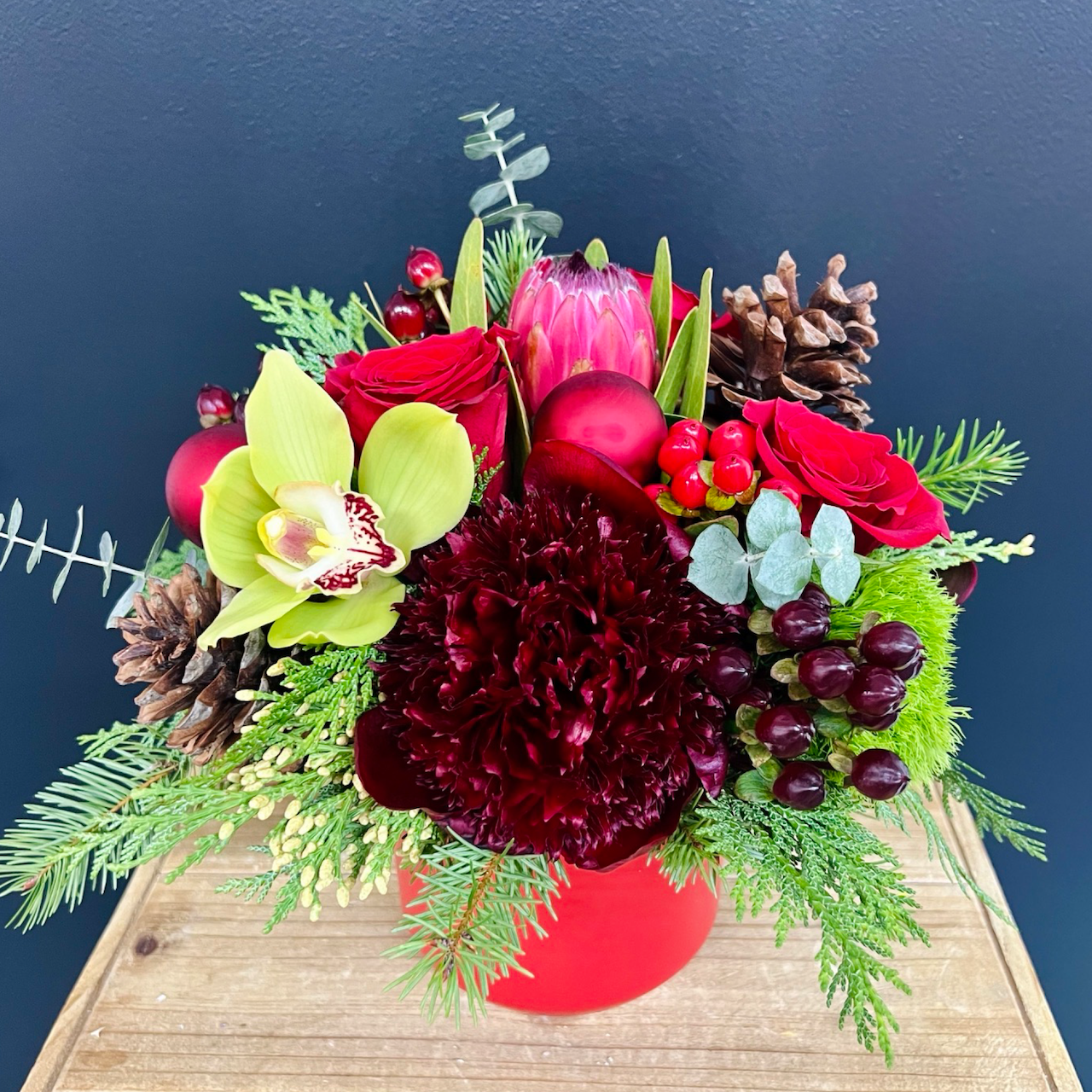 small red flower arrangement with a black background