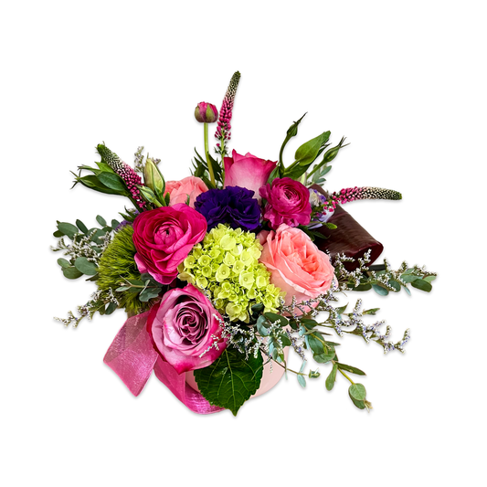 low and lush flower arrangement with pink, purple and green flowers