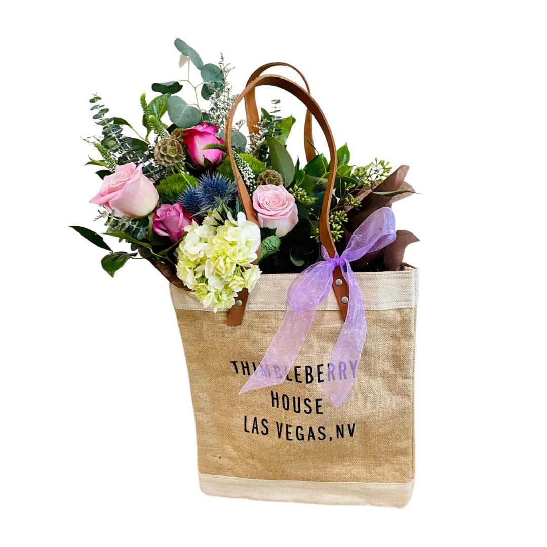 market bag with gathered bouquet and candle