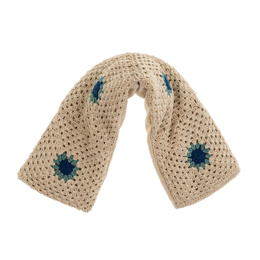 A beige hand crocheted therapy wrap with blue flower patterns, filled with lavender and flax seeds.