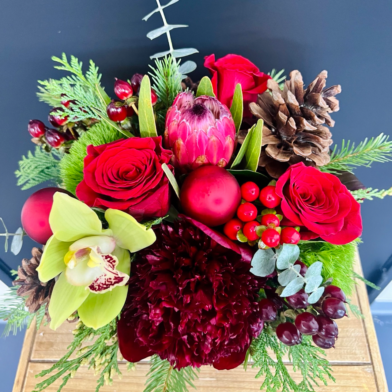 top view of small red holiday flowers on blackground