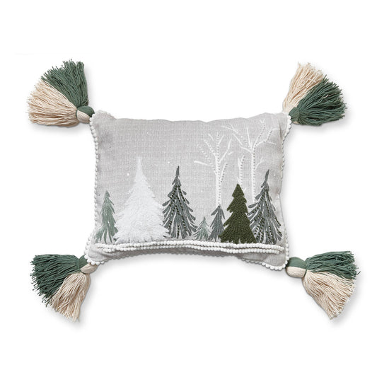 Decorative pillow with embroidered trees and tassels on a white background